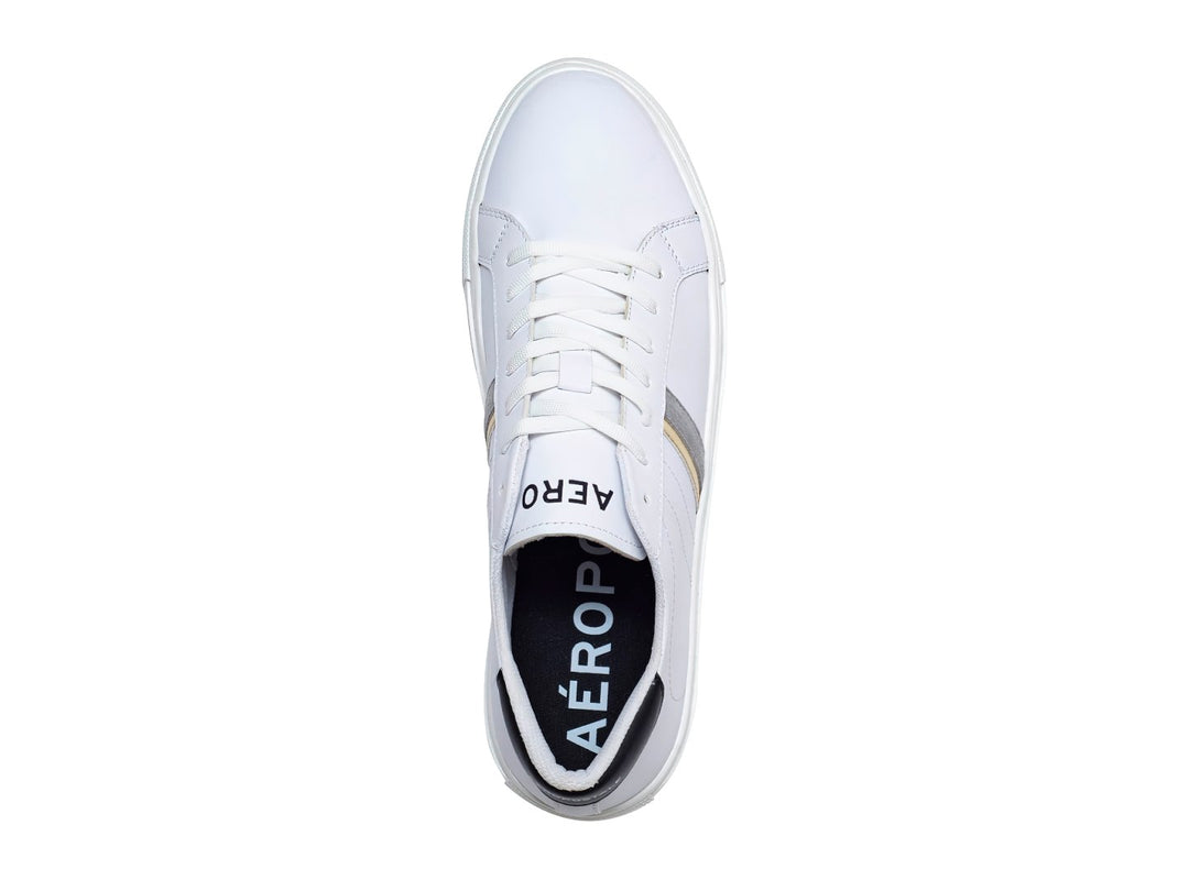 Tenis casuales Aeropostale color blanco con franjas laterales en dorado y gris, suela blanca y detalles negros en el talón.
