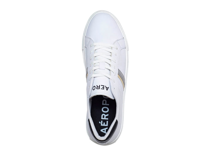 Tenis casuales Aeropostale color blanco con franjas laterales en dorado y gris, suela blanca y detalles negros en el talón.