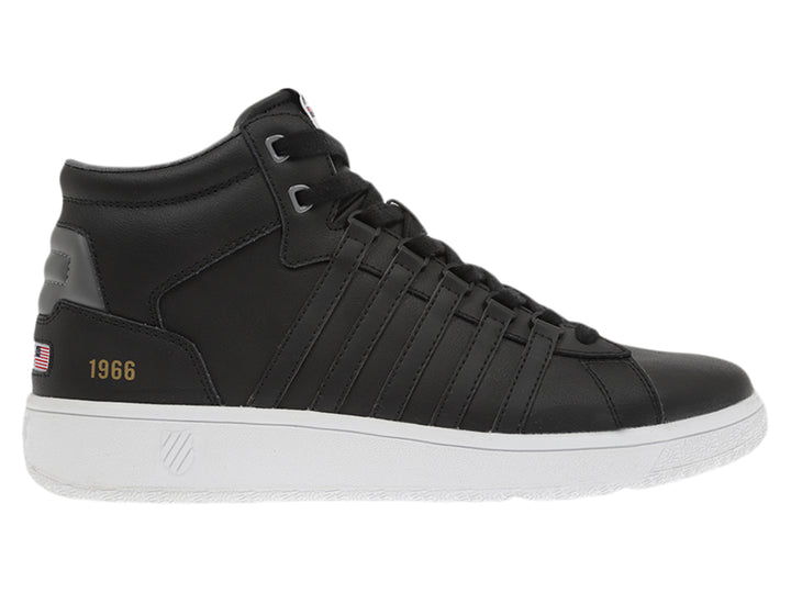 Tenis K-Swiss modelo Court P Mid en color negro con suela blanca y detalles dorados laterales.