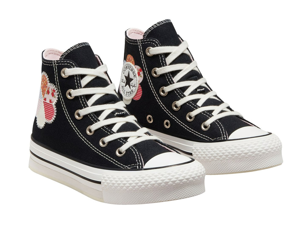 Tenis Converse Chuck Taylor All Star de caña alta en color negro con suela blanca y detalle floral colorido.