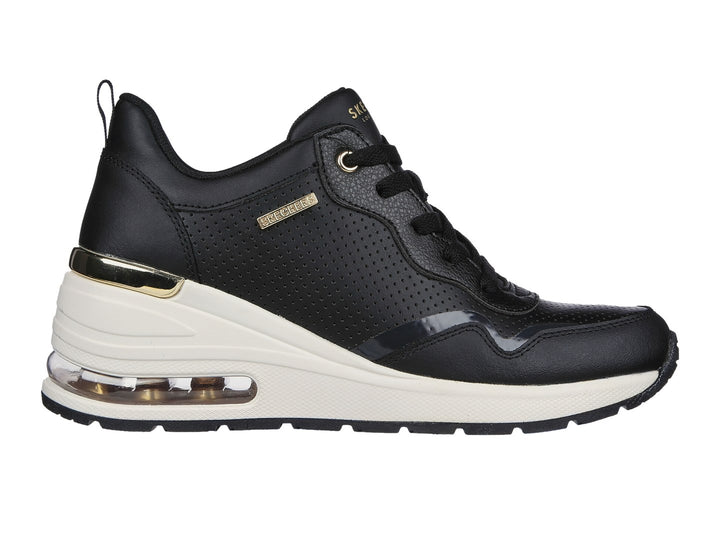 Tenis Skechers negros con suela blanca y detalles dorados.