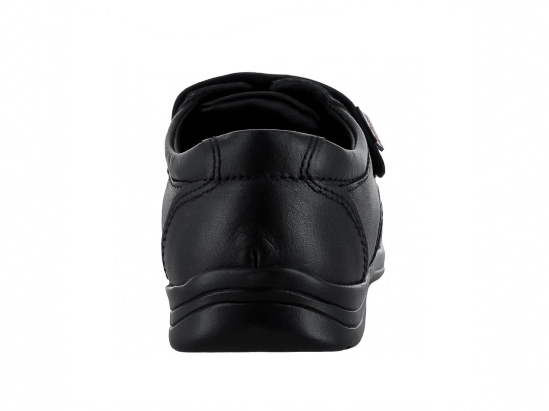 Zapato infantil color negro con cierre de velcro y acabado mate.