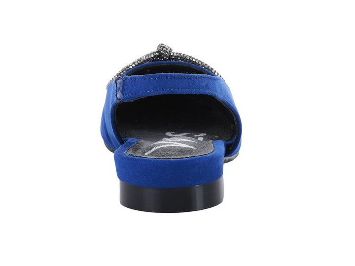 Zapato plano azul para niña con correa posterior y moño decorativo brillante.