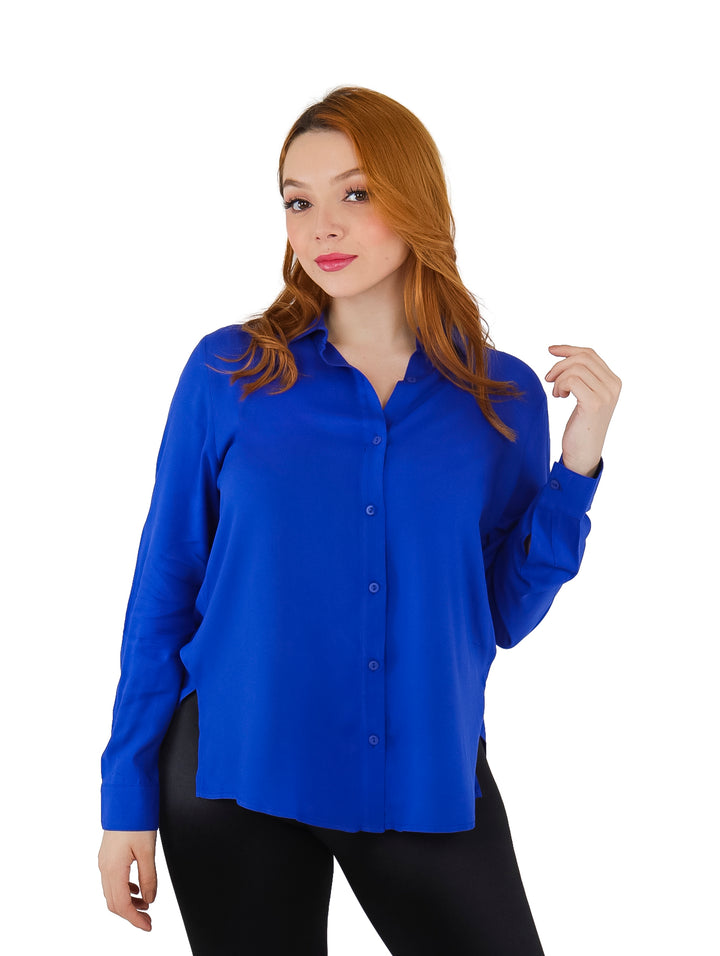 Mujer vistiendo una camisa de maternidad color azul rey de manga larga y pantalones negros.