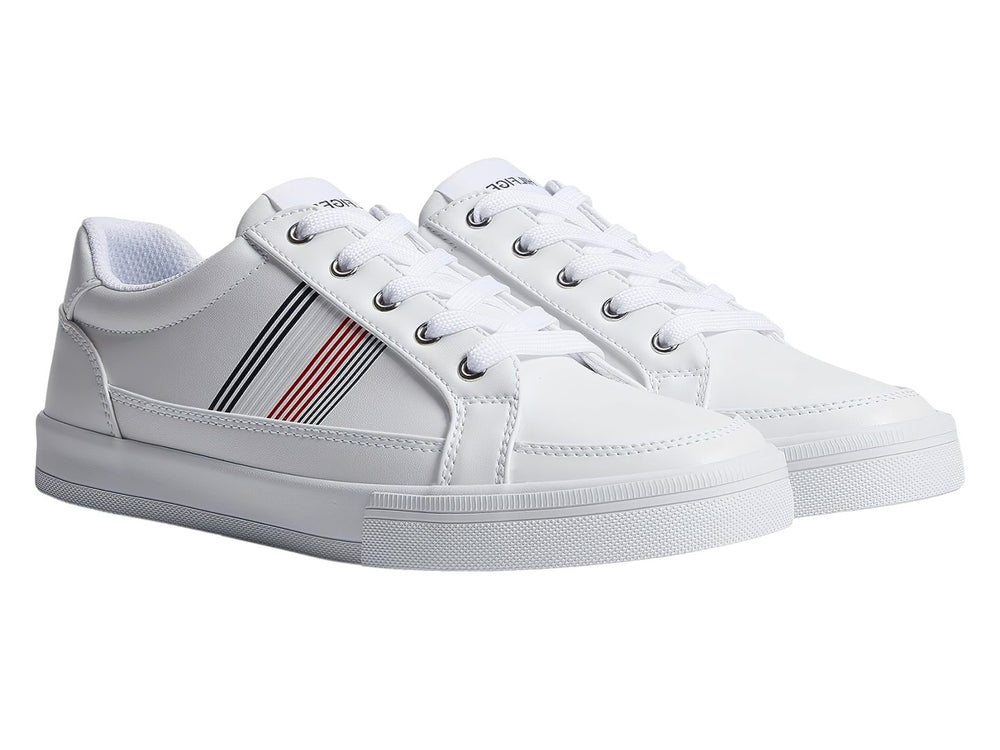 Tenis Tommy Hilfiger color blanco con rayas decorativas en azul y rojo en el lateral y suela blanca.