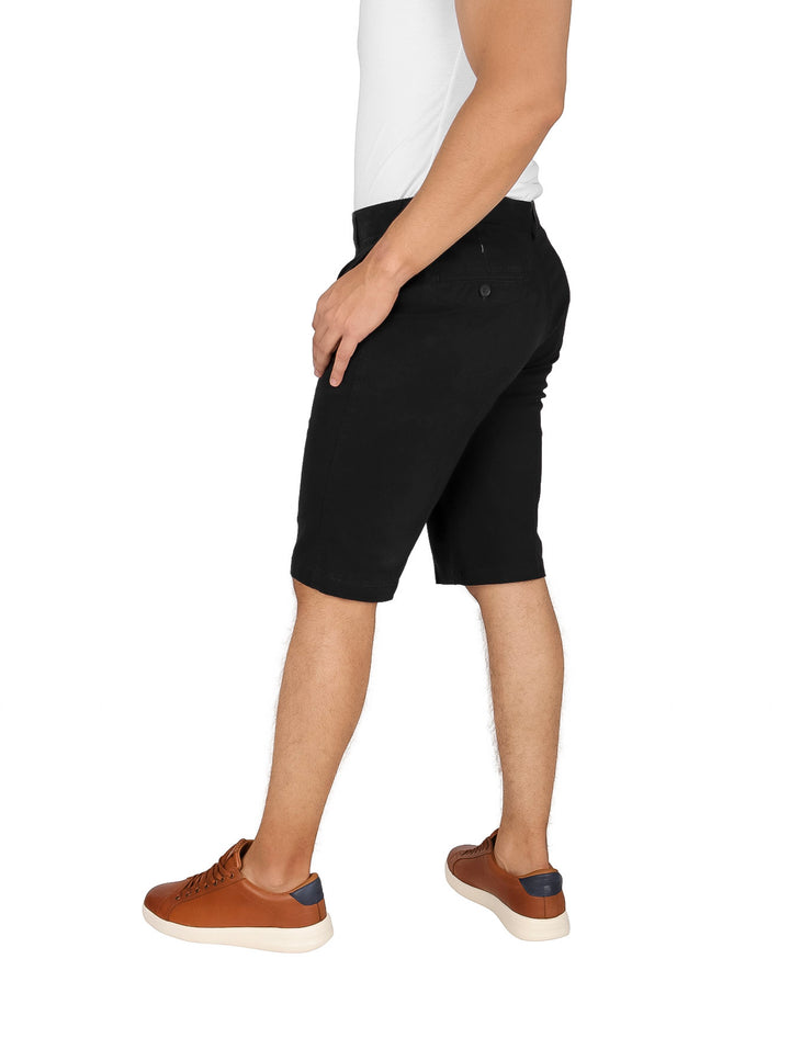 Hombre vistiendo bermudas chino color negro de corte casual.