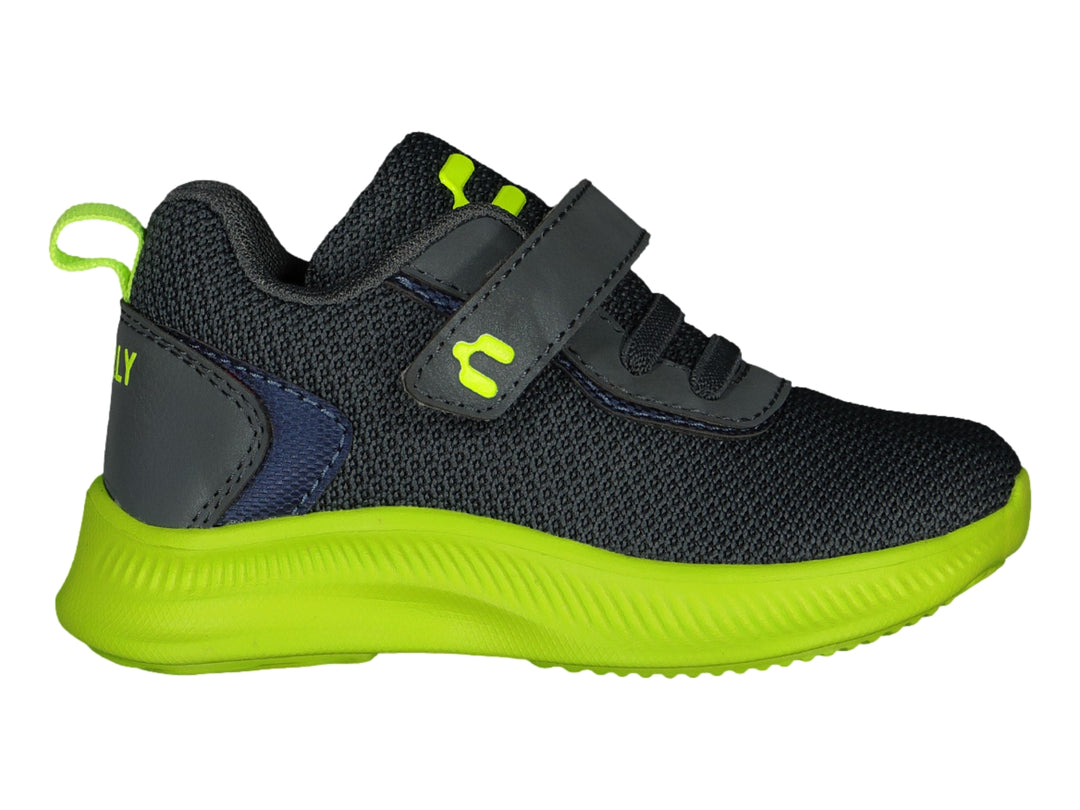Tenis deportivos infantiles color gris con suela verde lima y cierre de velcro.