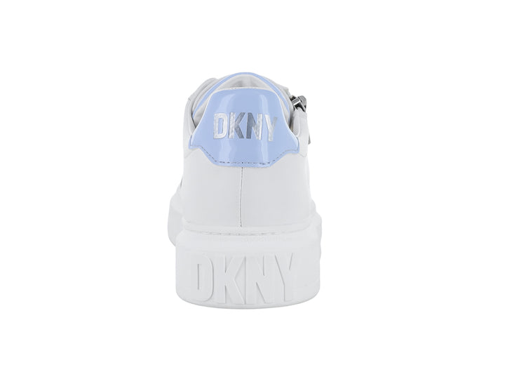 Tenis blancos DKNY con agujetas color lavanda, suela gruesa y cierre lateral plateado.