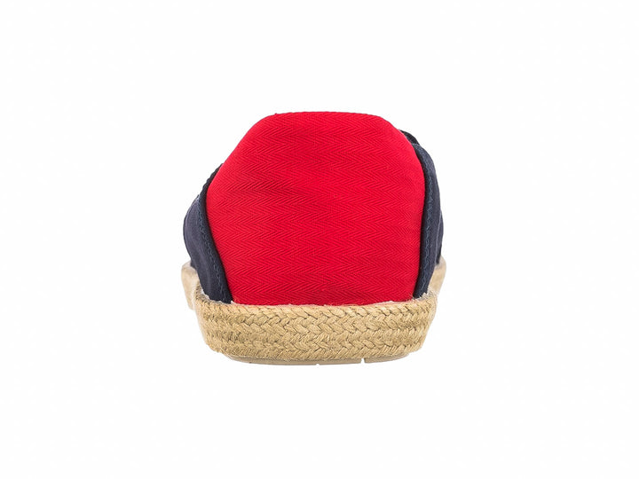 Zapato plano estilo alpargata en color azul marino con talón rojo y suela de yute natural.