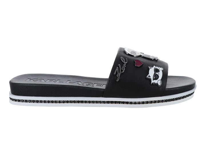Sandalia slide negra con parches decorativos y suela blanca con detalles brillantes.