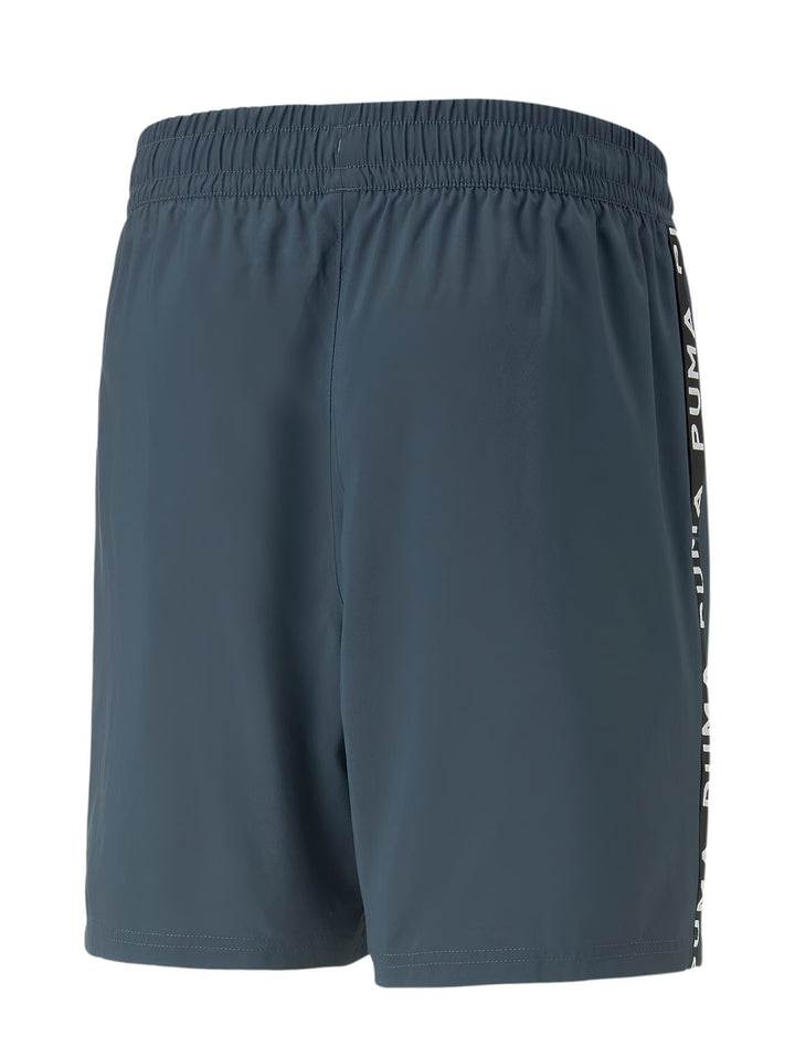 Shorts deportivos PUMA color azul oscuro con cinta lateral negra y logotipo blanco.