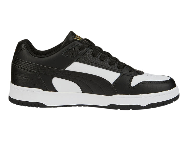 Tenis PUMA RBD Game Low en colores negro y blanco con detalles dorados, diseño deportivo de corte bajo.