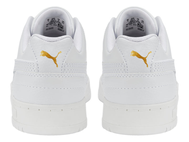 Tenis PUMA RBD Game Low JR en color blanco con detalles dorados, diseño deportivo de corte bajo para niños.
