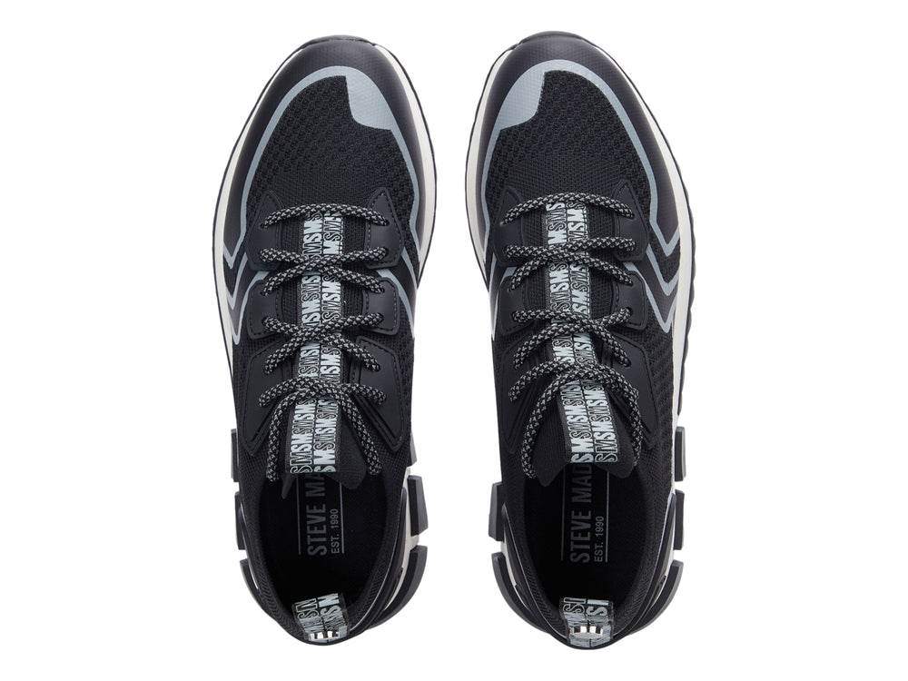 Tenis deportivos Steve Madden Decon en color negro con detalles en gris y suela blanca y negra.