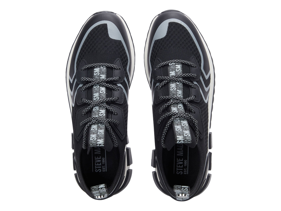 Tenis deportivos Steve Madden Decon en color negro con detalles en gris y suela blanca y negra.