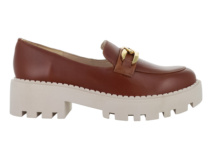 Zapato mocasín de piel color miel con hebilla dorada y suela blanca ancha tipo plataforma.