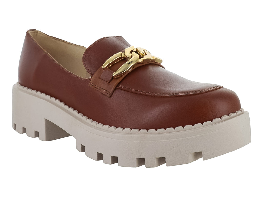 Zapato mocasín de piel color miel con hebilla dorada y suela blanca ancha tipo plataforma.