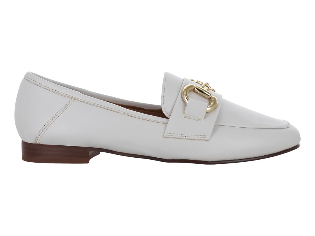 Zapato tipo mocasín color latte para mujer con herraje metálico dorado en la parte superior.