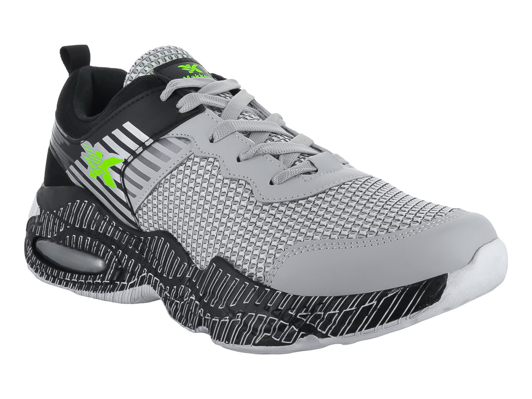 Tenis deportivos infantiles en color gris y negro con detalles en verde neón y suela texturizada.