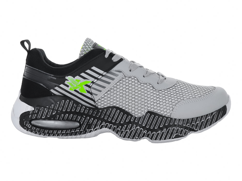 Tenis deportivos infantiles en color gris y negro con detalles en verde neón y suela texturizada.