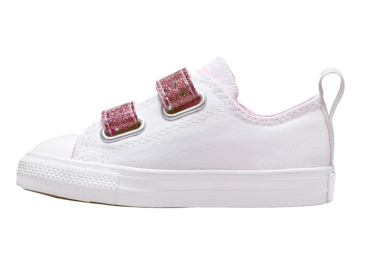 Tenis Converse blancos con correas de velcro rosa con glitter.