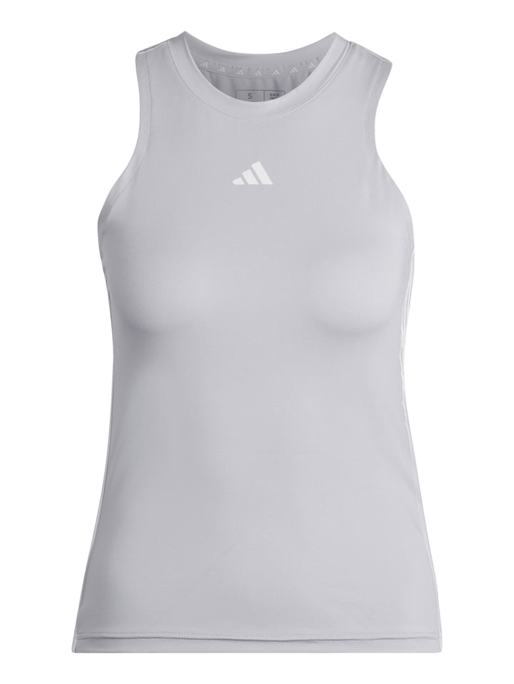 Mujer vistiendo una camiseta deportiva Adidas sin mangas en color silver dawn con detalles blancos laterales.