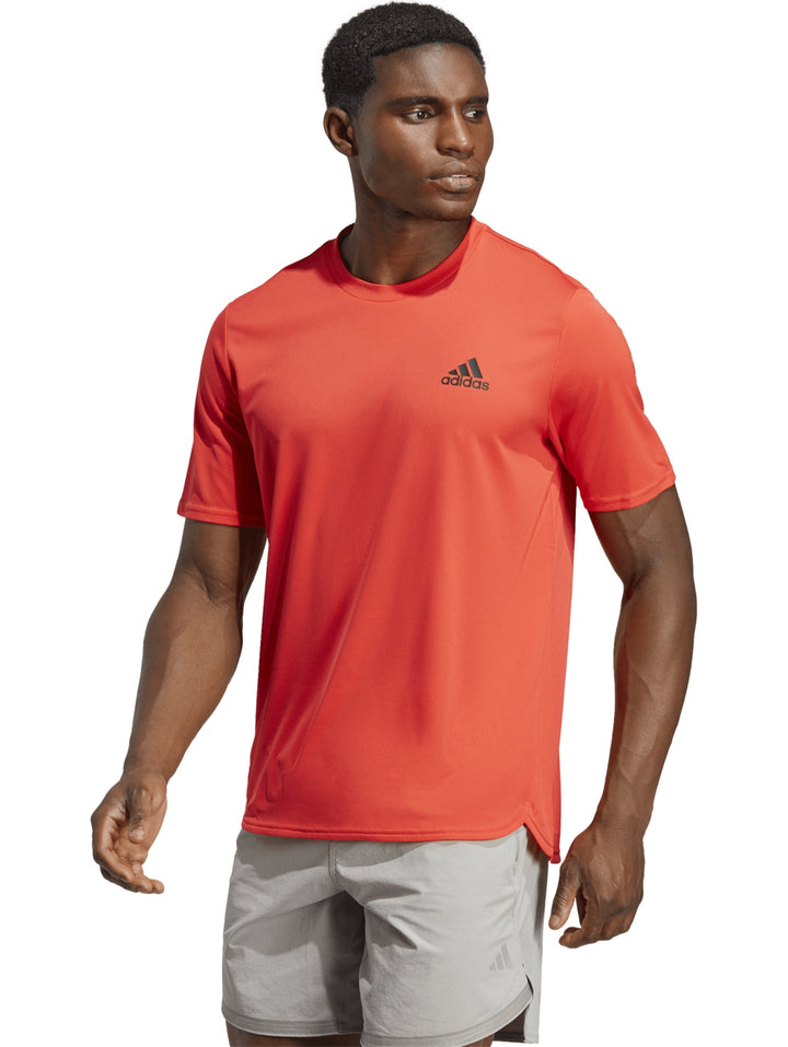 Camiseta deportiva Adidas de color rojo brillante con cuello redondo y manga corta.