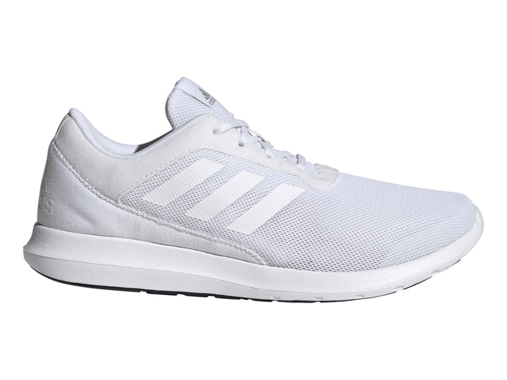 Tenis deportivos Adidas Coreacer en color blanco con detalles plateados y suela blanca.