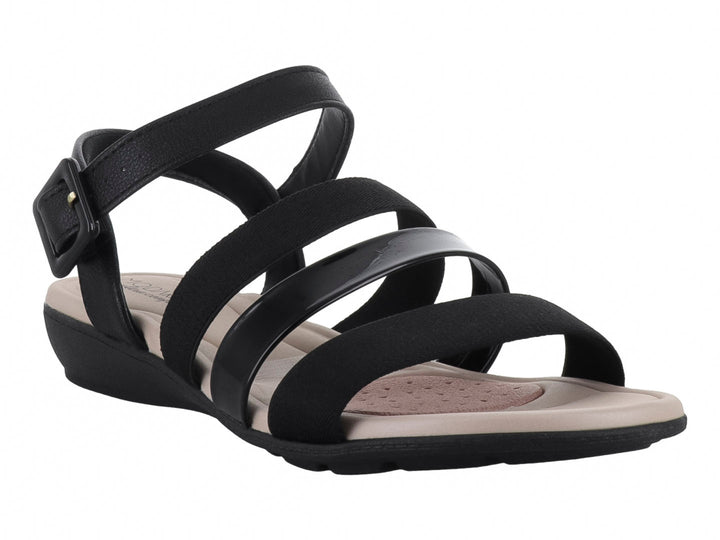 Sandalia Modare de tiras negras elásticas y brillantes con plantilla y suela color beige.
