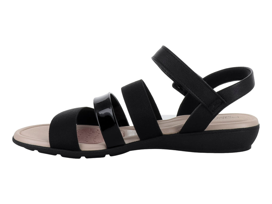 Sandalia Modare de tiras negras elásticas y brillantes con plantilla y suela color beige.