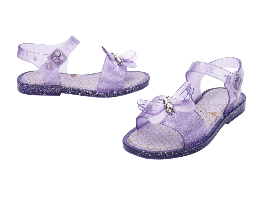 Sandalias moradas brillantes para niña con adorno de mariposa y suela con glitter.
