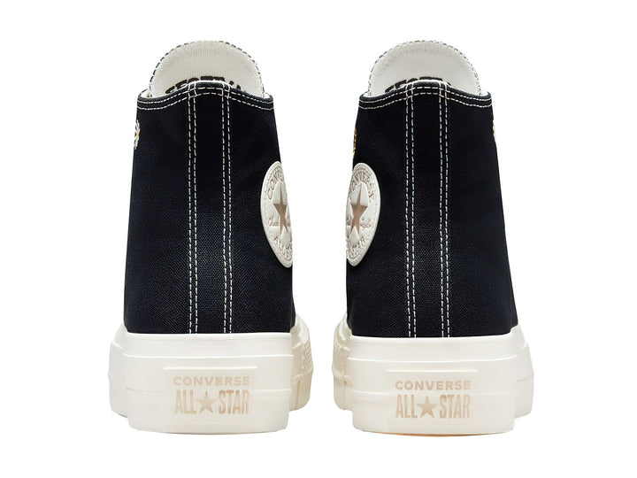 Tenis Converse Chuck Taylor All Star Lift HI color negro con bordados de flores doradas y suela blanca.