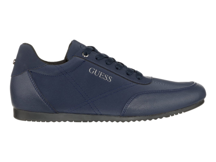 Tenis casuales de color azul marino marca Guess con cordones y suela oscura.