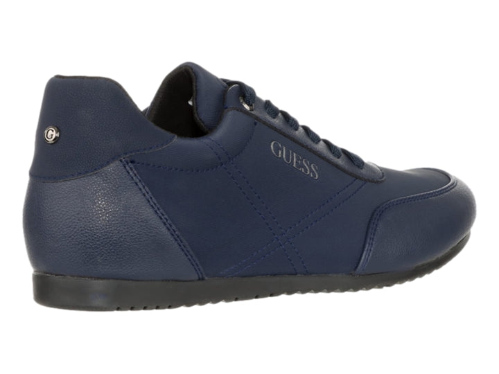 Tenis casuales de color azul marino marca Guess con cordones y suela oscura.