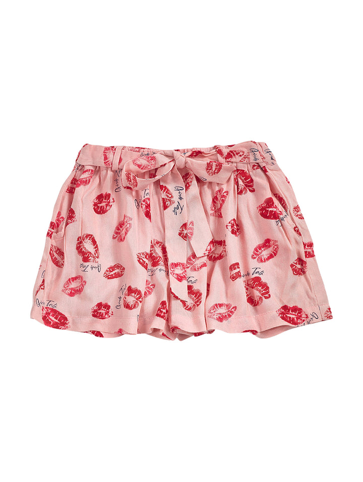 Short falda rosa para niña con estampado de labios rojos y lazo en la cintura.