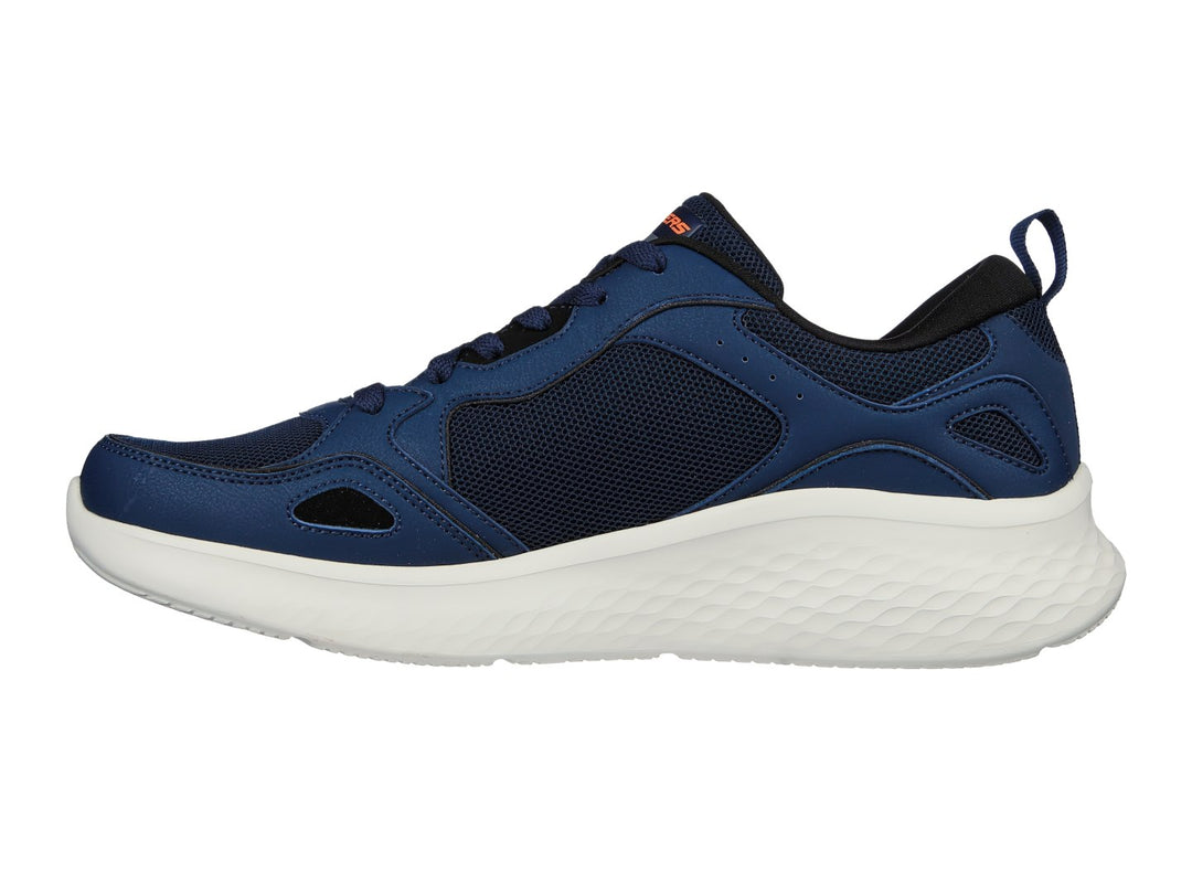 Tenis deportivos Skech-Lite Pro en color azul marino con suela blanca y detalles en naranja.