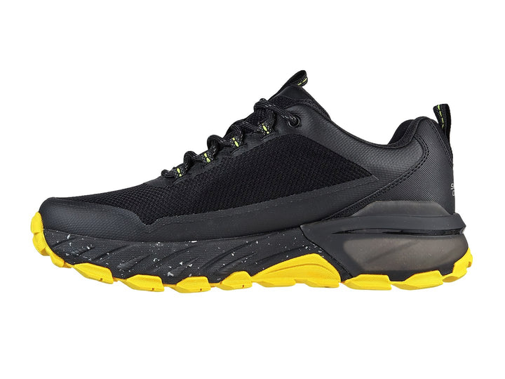 Tenis deportivos Skechers color negro con suela amarilla y tejido de malla.