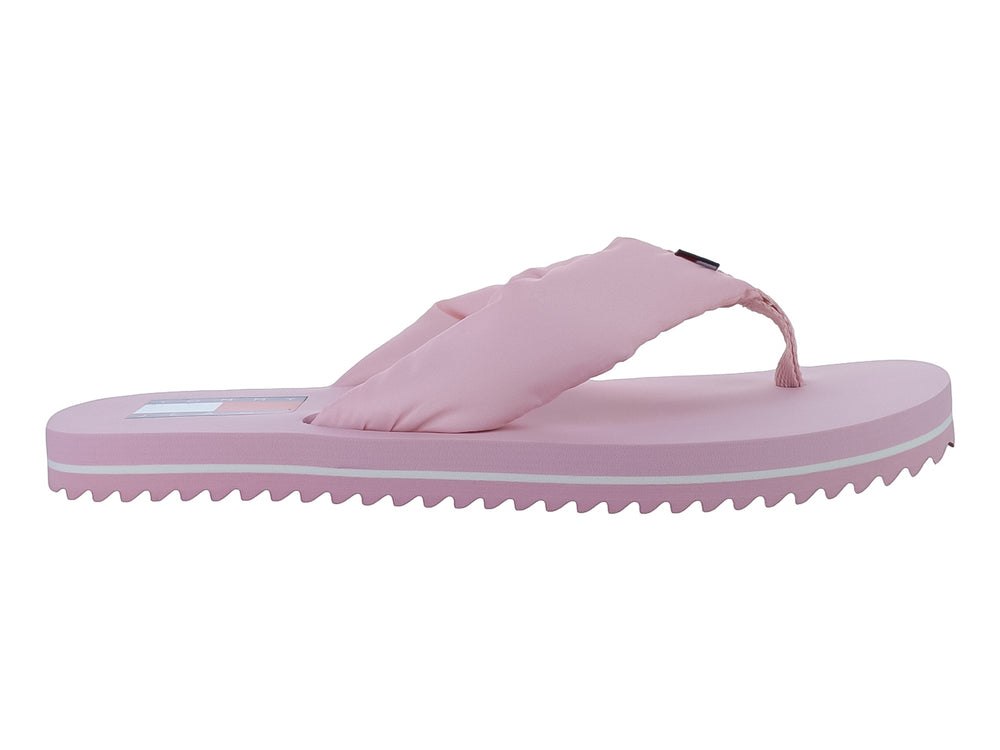Sandalias de dedo color rosa con correa de tela y una línea blanca en la suela.