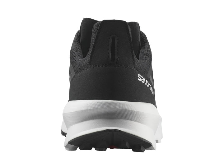 Tenis deportivos Salomon de color negro con suela blanca y detalles en rojo.