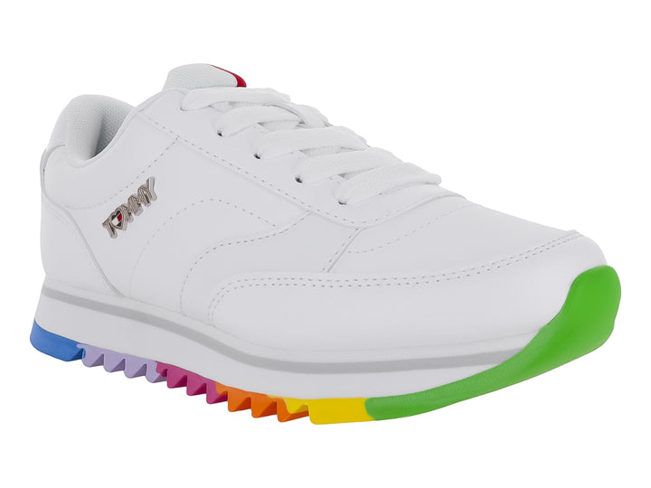 Tenis blancos Tommy Hilfiger con suela multicolor arcoíris y agujetas blancas.
