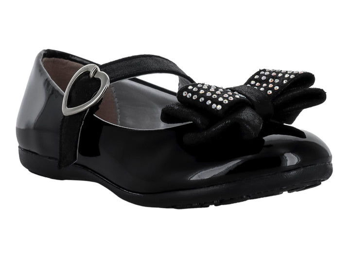 Zapato plano negro de charol con moño decorado y hebilla en forma de corazón.