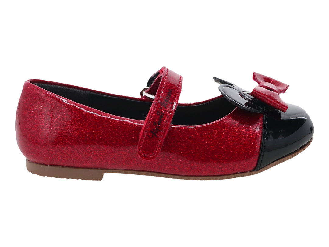 Zapato rojo brillante para niña con punta negra y moño decorativo en la parte superior.