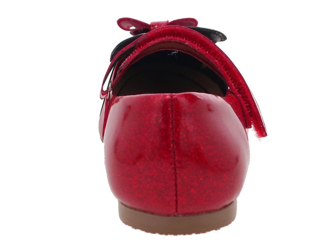 Zapato rojo con brillos y punta negra de charol con moño decorativo para niña.