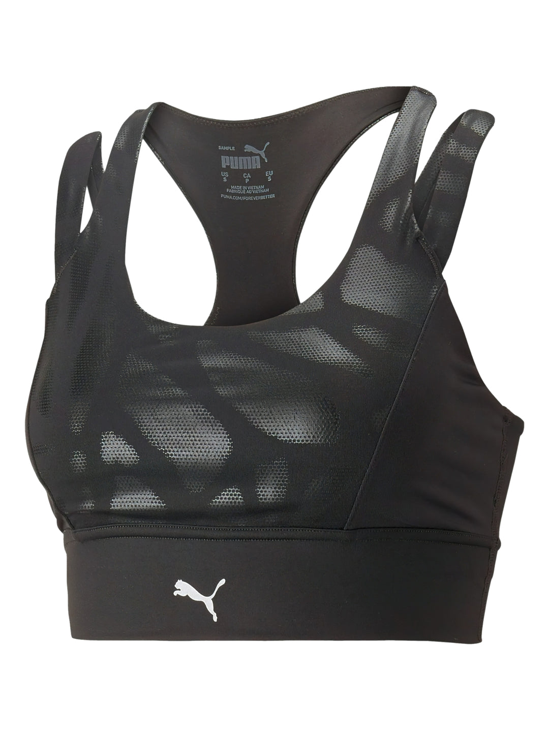 Mujer vistiendo un top deportivo PUMA color negro brillante de impacto medio con tirantes y logo frontal.