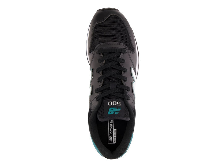 Tenis New Balance color negro con detalles en turquesa y suela blanca.