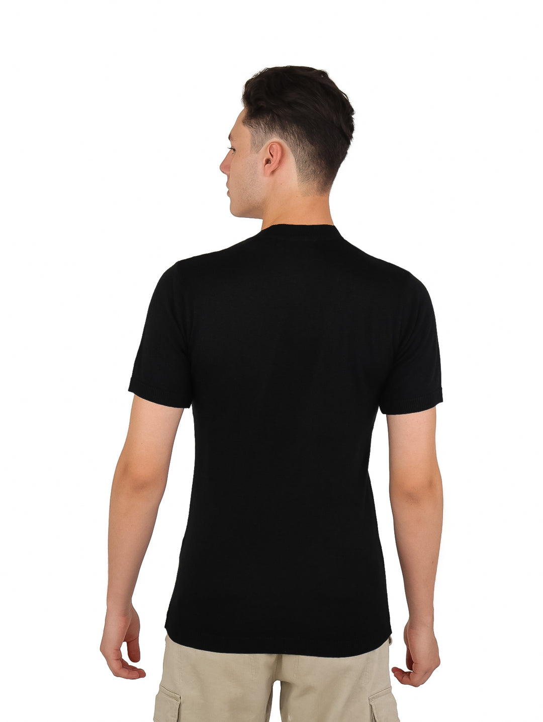 Hombre vistiendo una playera negra de manga corta con textura acanalada y pantalones beige.
