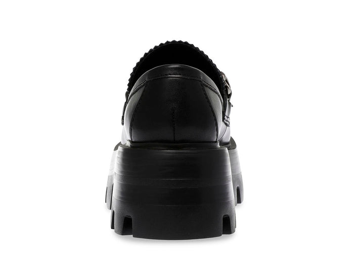 Zapato loafer negro con suela de plataforma gruesa y detalle de cadena plateada.