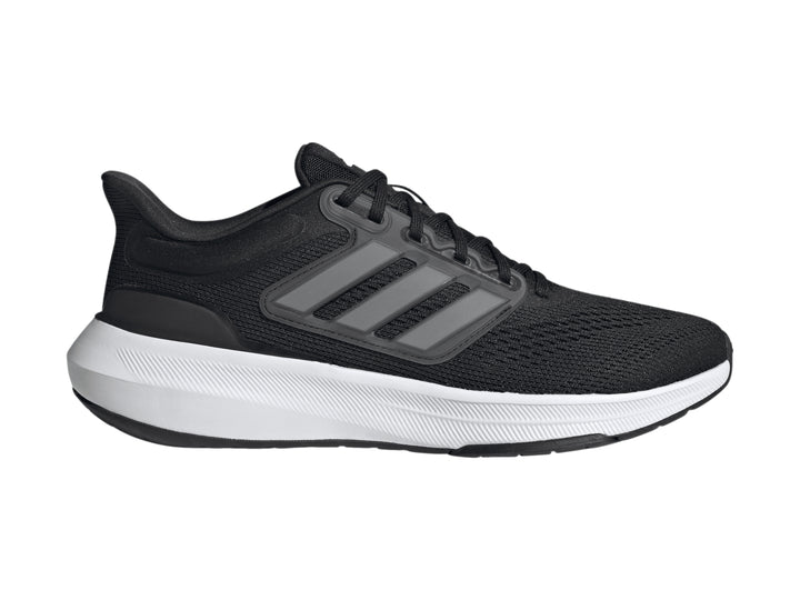 Tenis deportivos Adidas Ultrabounce color negro con suela blanca y detalles en gris.