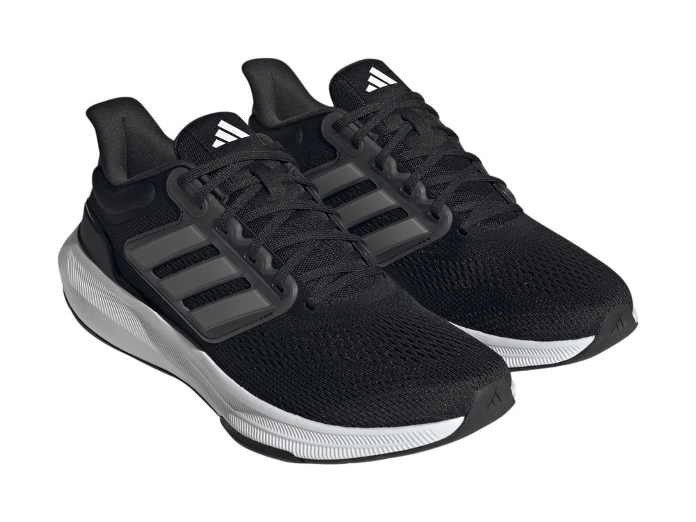 Tenis deportivos Adidas Ultrabounce color negro con suela blanca y detalles en gris.