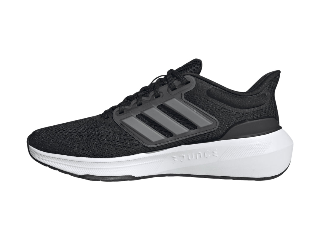 Tenis deportivos Adidas Ultrabounce color negro con suela blanca y detalles en gris.